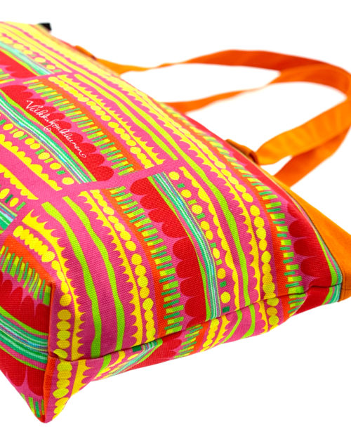 Virkkukoukkusen suunnittelema Suomessa tehty Reilu-laukku vetoketjullisella sisätaskulla. Kuosina iloisen värikäs Optimisti oransseilla kahvoilla.