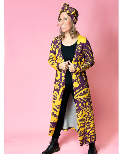 Suomessa valmistettu pitkä ja naisellinen takki. Miellyttävää ja ryhdikkästä Ponte Roma -neulosta. Pitkät hihat ja yhden napin nepparikiinnitys. Kuosina upea Luumu-keltainen Krumeluuri, jossa on luumun violetilla pohjalla lämpimän keltaisia kiemuraisia ja näyttäviä suuria abstrakteja ja kukkamaisia kuvioita.